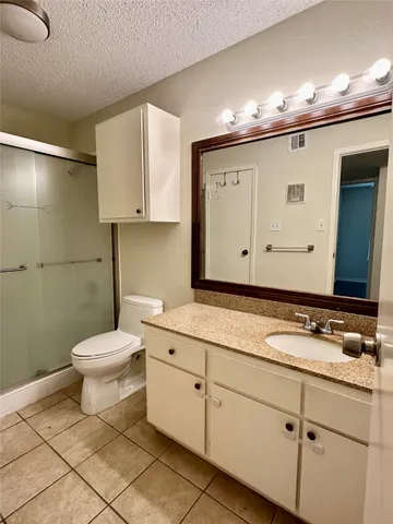 a bathroom with a sink a toilet and mirror