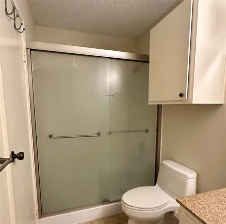 a white toilet sitting next to a bathroom sink