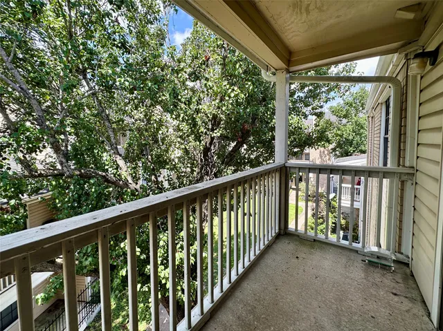 a view of a balcony with wooden floor