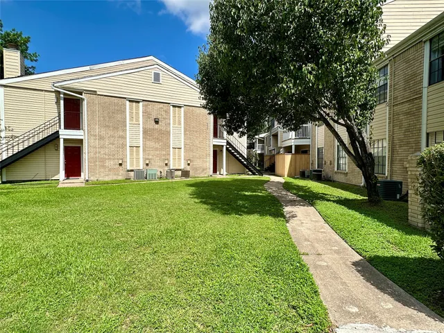 a front view of a house with yard and green space