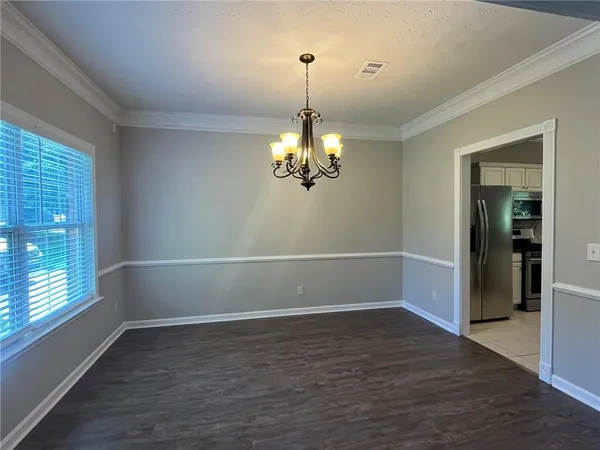an empty room with wooden floor and a fireplace