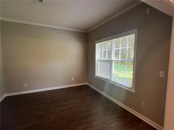 a view of a livingroom with wooden floor and a fireplace