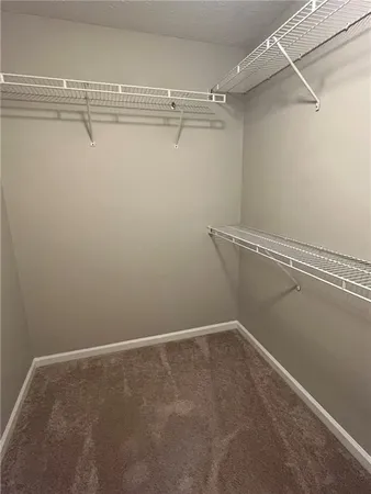 a view of a hallway with wooden shelves