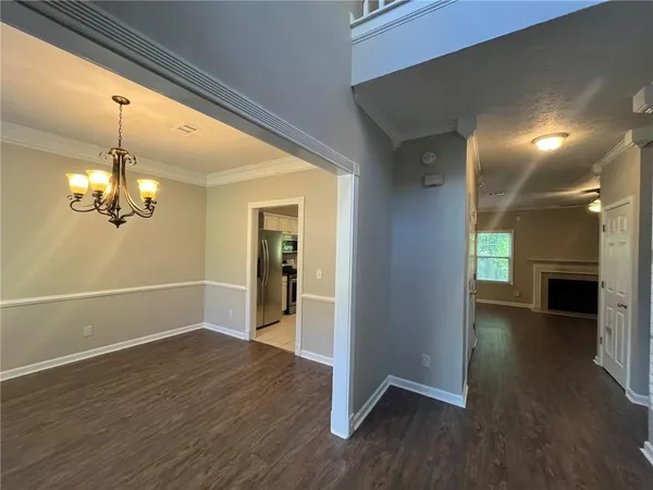 an empty room with windows and entrance