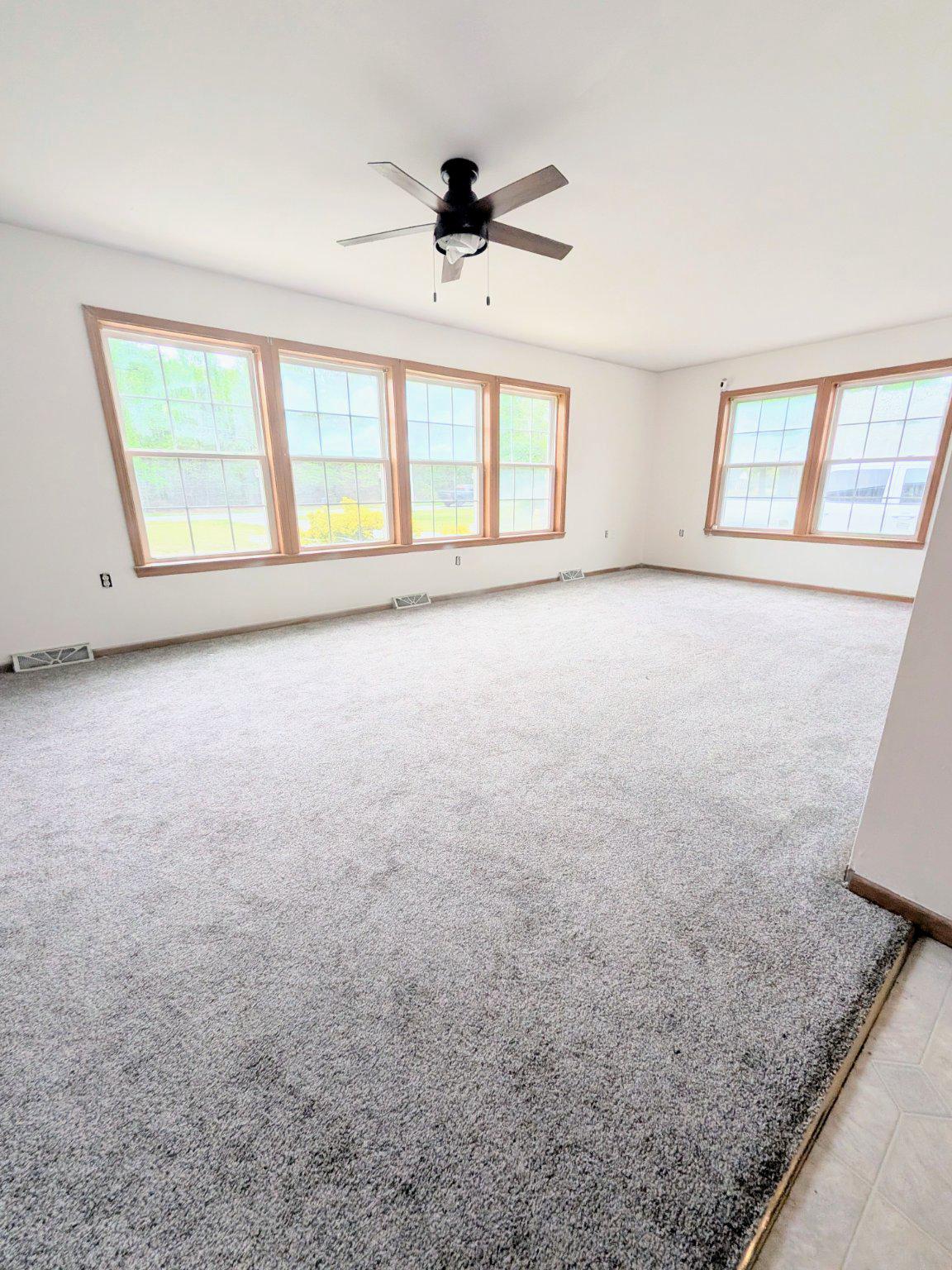 575 Jackson Ditch Road Harrington, DE 19952 - Photo 11 of 39 an empty room with windows and ceiling fan