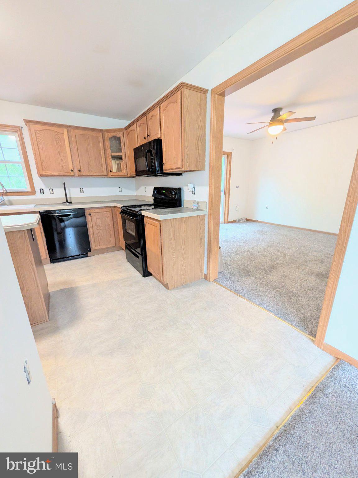575 Jackson Ditch Road Harrington, DE 19952 - Photo 8 of 39 a large white kitchen with stainless steel appliances