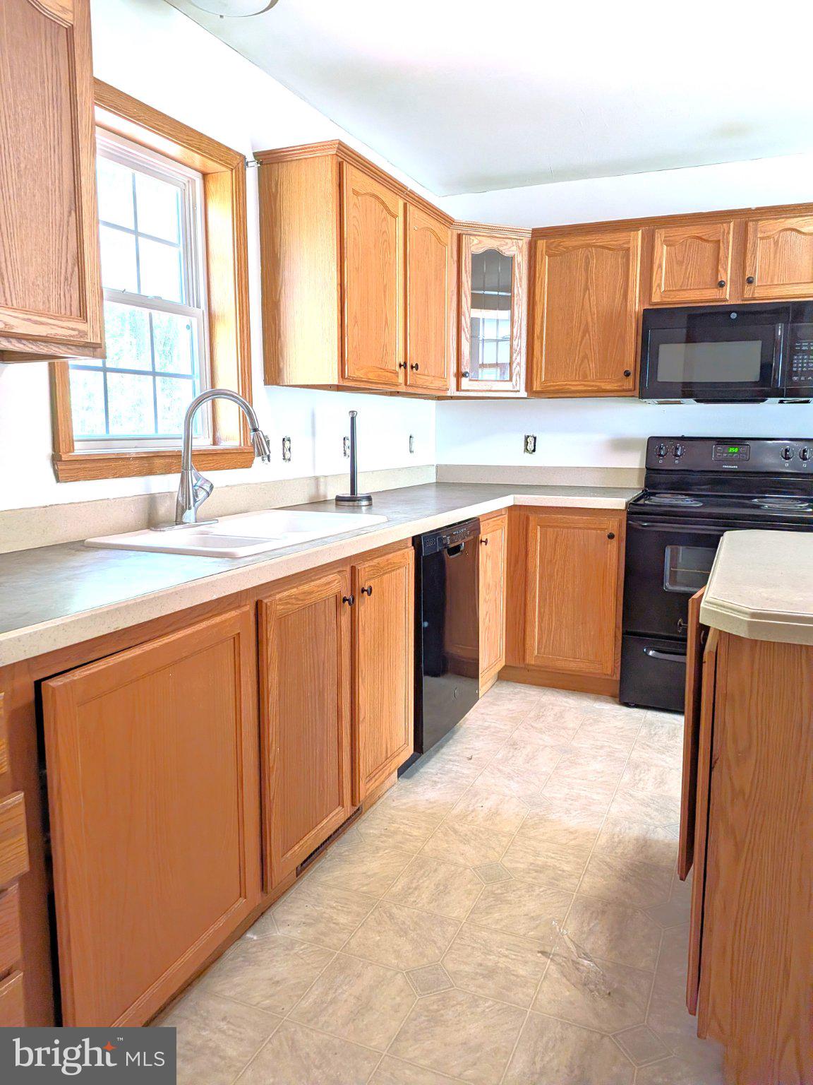 575 Jackson Ditch Road Harrington, DE 19952 - Photo 9 of 39 a kitchen with stainless steel appliances granite countertop a sink stove and refrigerator