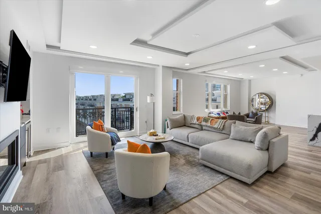 a living room with fireplace furniture and a flat screen tv