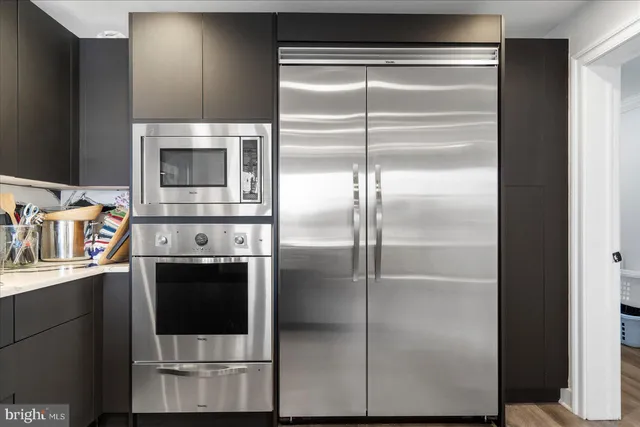 a kitchen with a refrigerator and a stove
