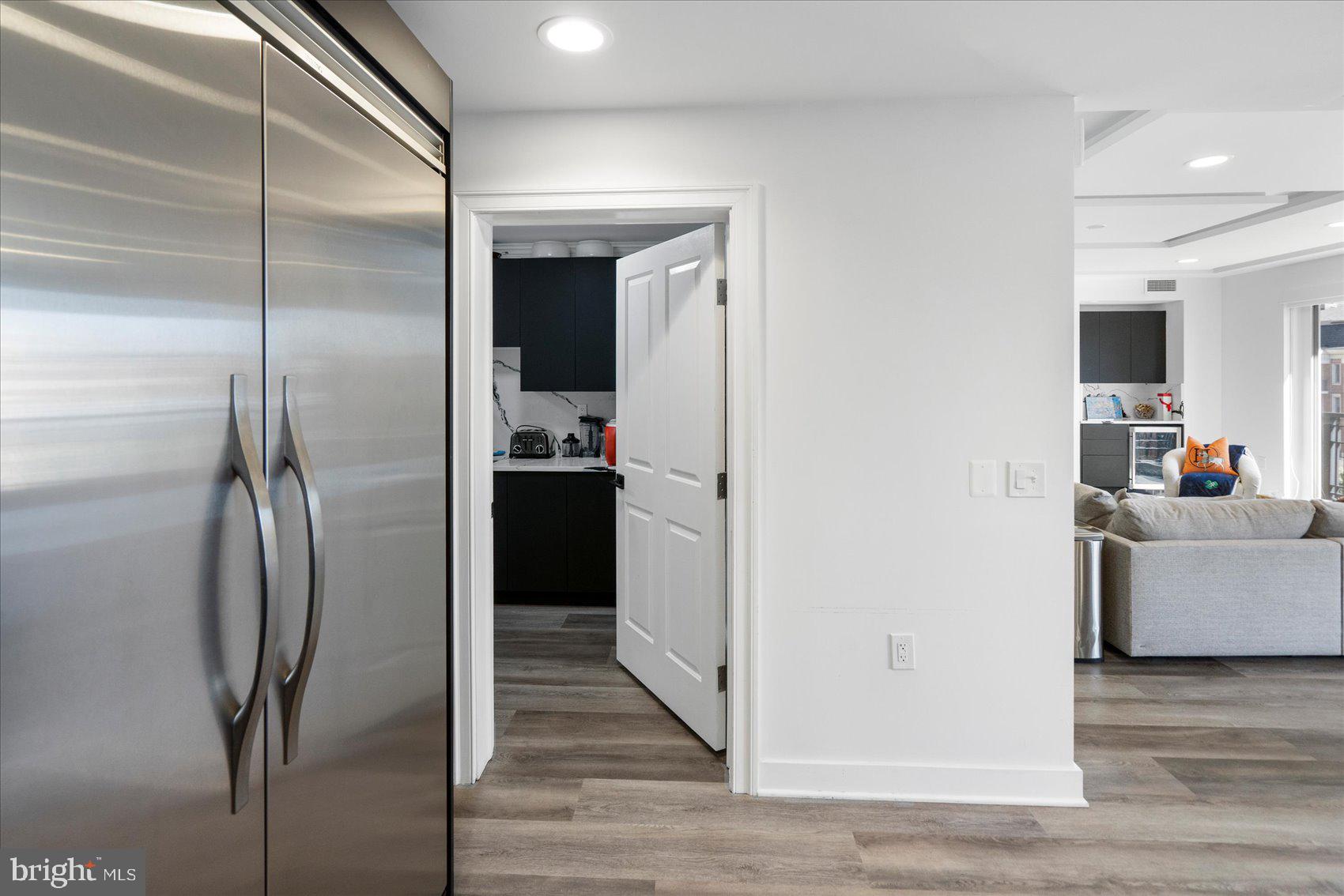 801 Key Highway, Unit T63 Baltimore, MD 21230 - Photo 18 of 43 a kitchen with stainless steel appliances a refrigerator and a wooden floor
