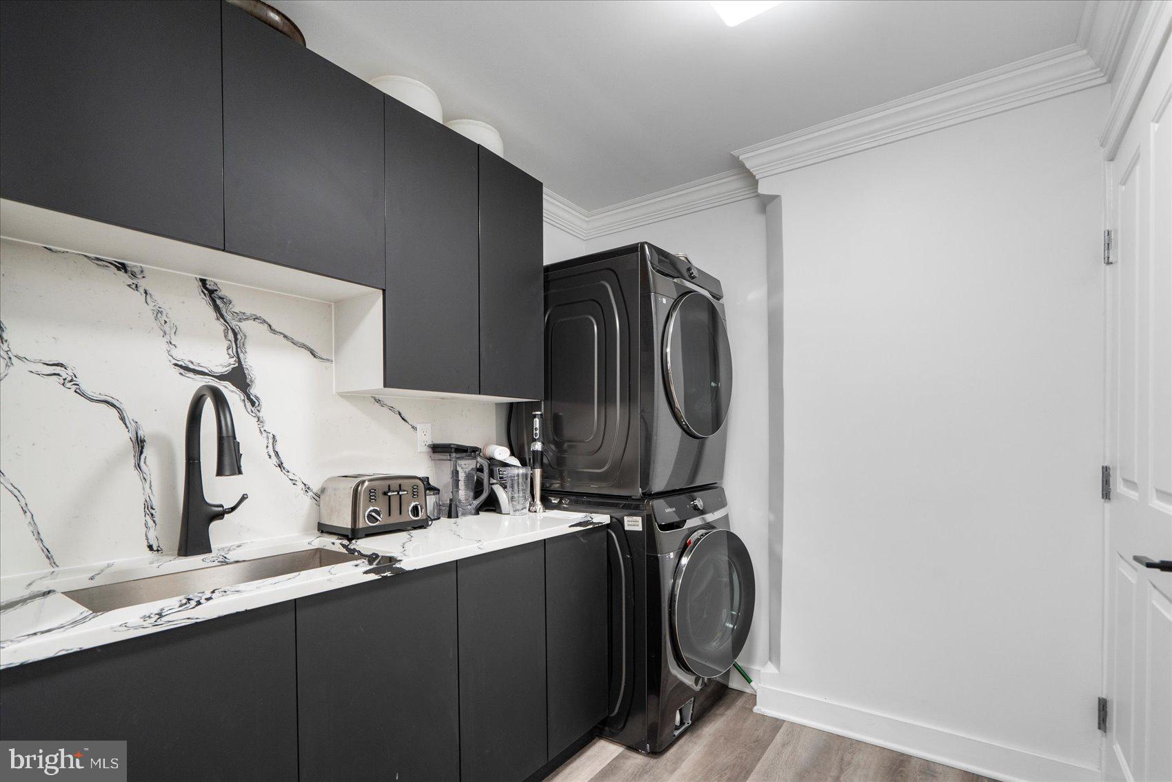 801 Key Highway, Unit T63 Baltimore, MD 21230 - Photo 19 of 43 a utility room with multiple dryer and washer