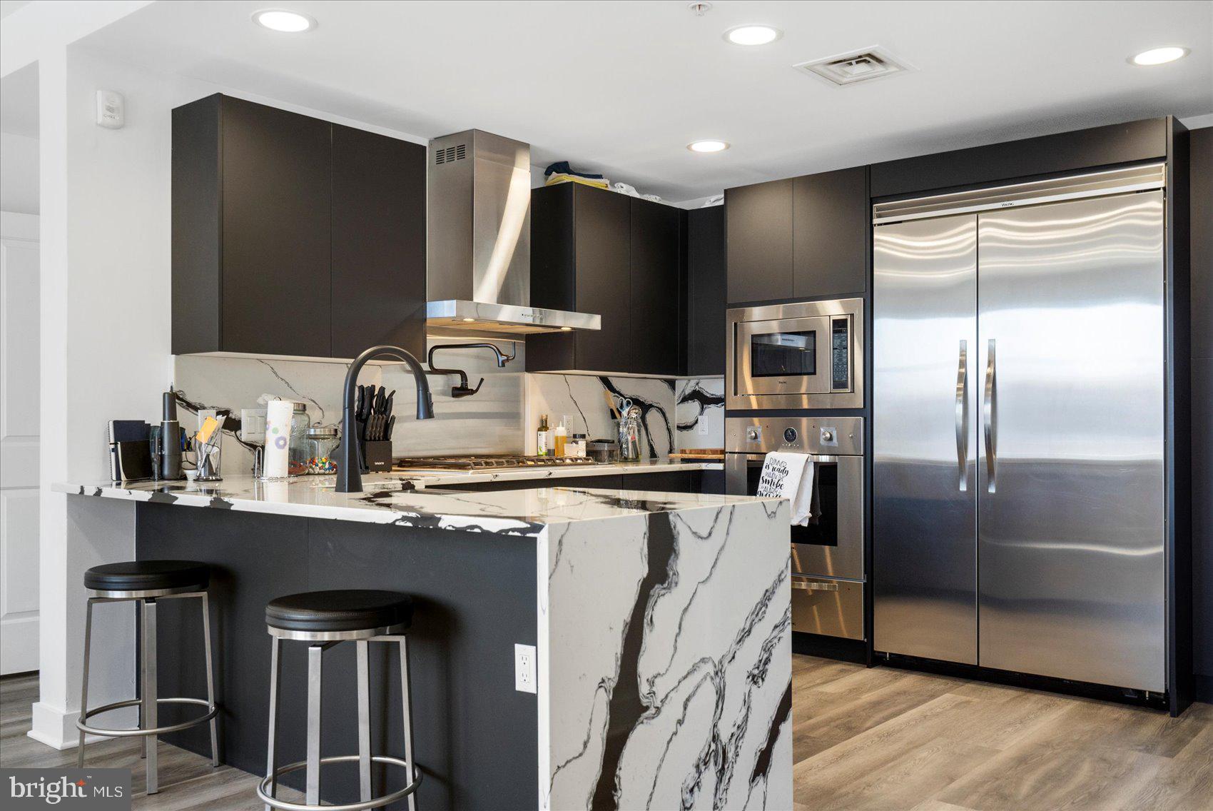 801 Key Highway, Unit T63 Baltimore, MD 21230 - Photo 21 of 43 a kitchen with stainless steel appliances granite countertop a refrigerator a sink a stove and a refrigerator