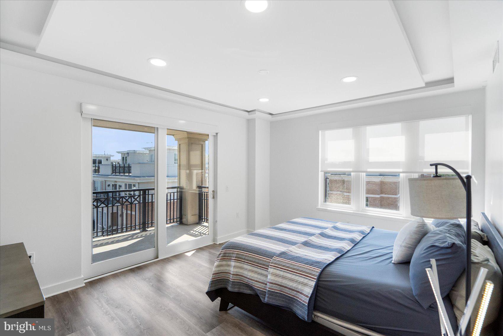 801 Key Highway, Unit T63 Baltimore, MD 21230 - Photo 27 of 43 a bedroom with a large bed and a large window with outer view