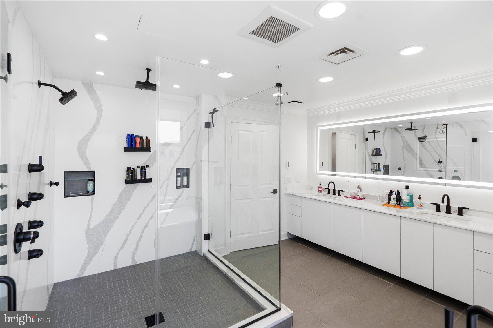 801 Key Highway, Unit T63 Baltimore, MD 21230 - Photo 30 of 43 a large bathroom with a double vanity sink and mirror with shower