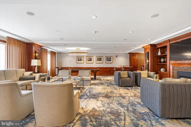 a living room with lots of furniture pool table and chairs