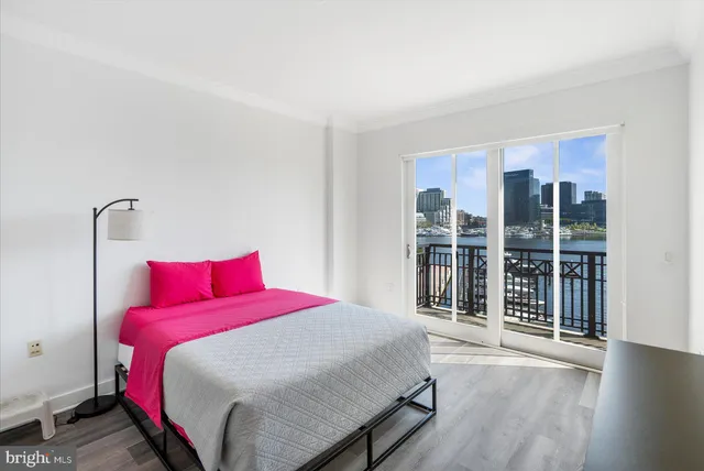 a bedroom with a large bed and a large window