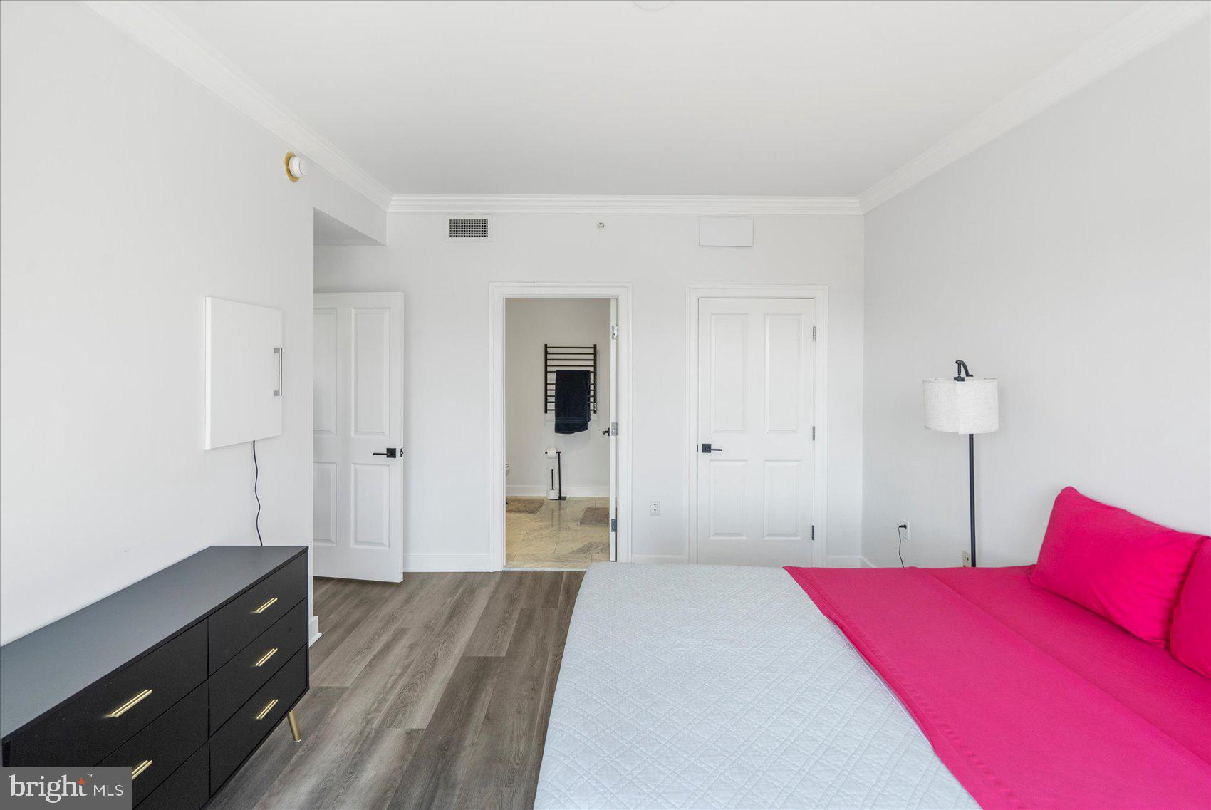 801 Key Highway, Unit T63 Baltimore, MD 21230 - Photo 6 of 43 a bedroom with a bed and a dresser