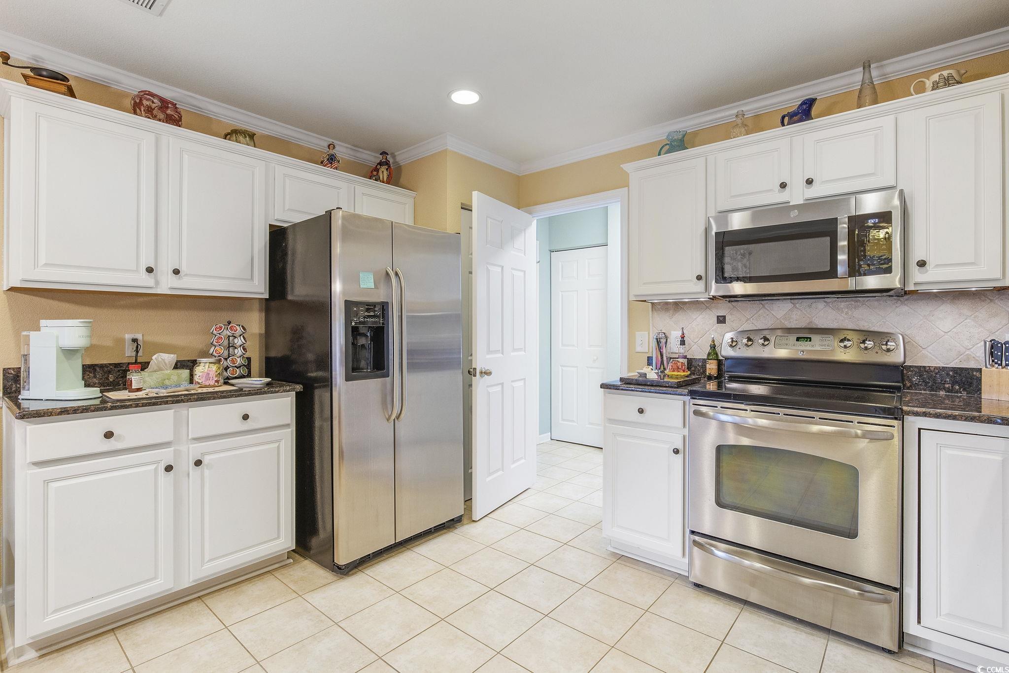 749 Bonita Loop Myrtle Beach, SC 29588 - Photo 9 of 37 Kitchen with tasteful backsplash, white cabinets,