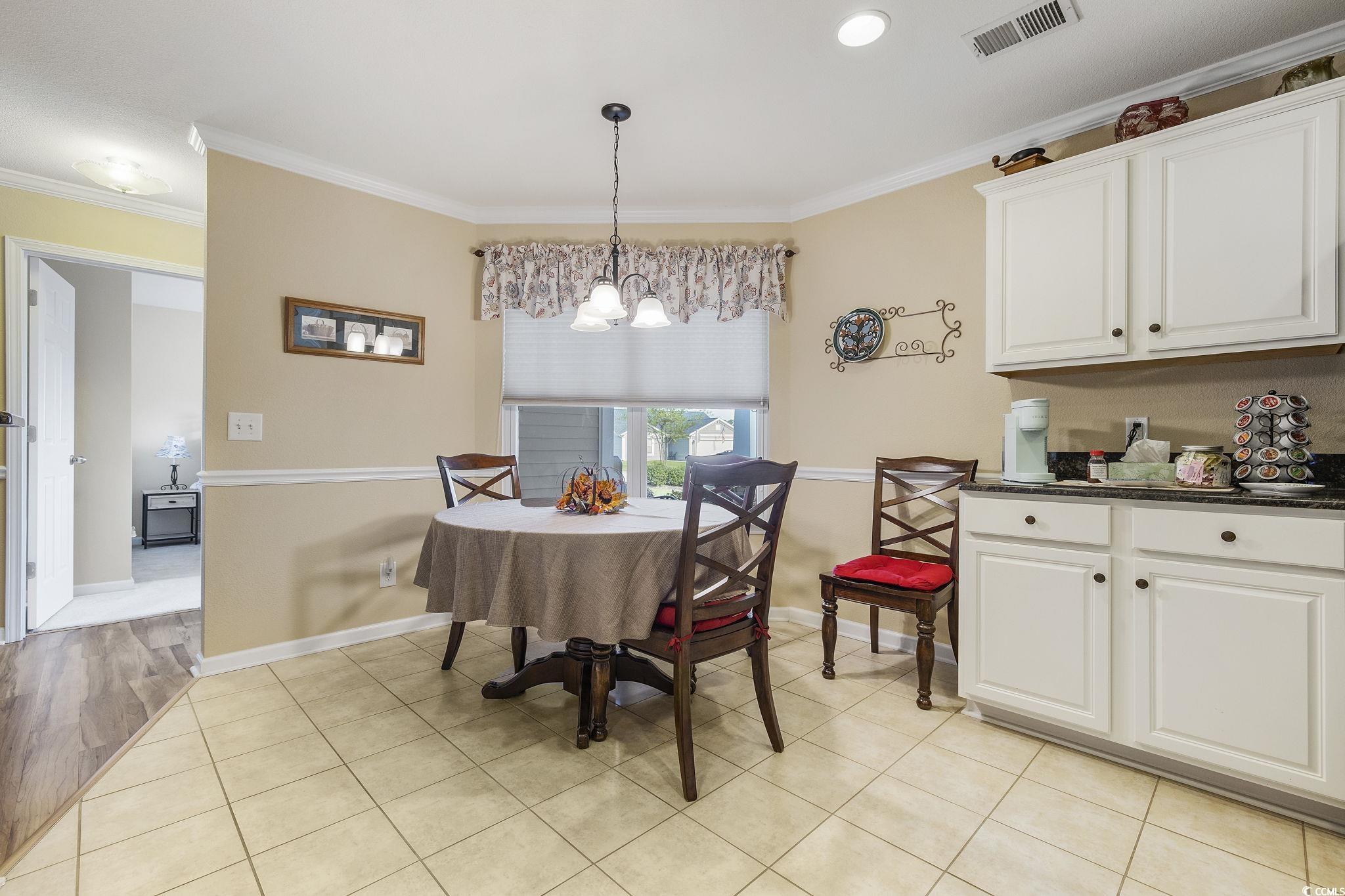 749 Bonita Loop Myrtle Beach, SC 29588 - Photo 10 of 37 Dining area featuring ornamental molding, a chande
