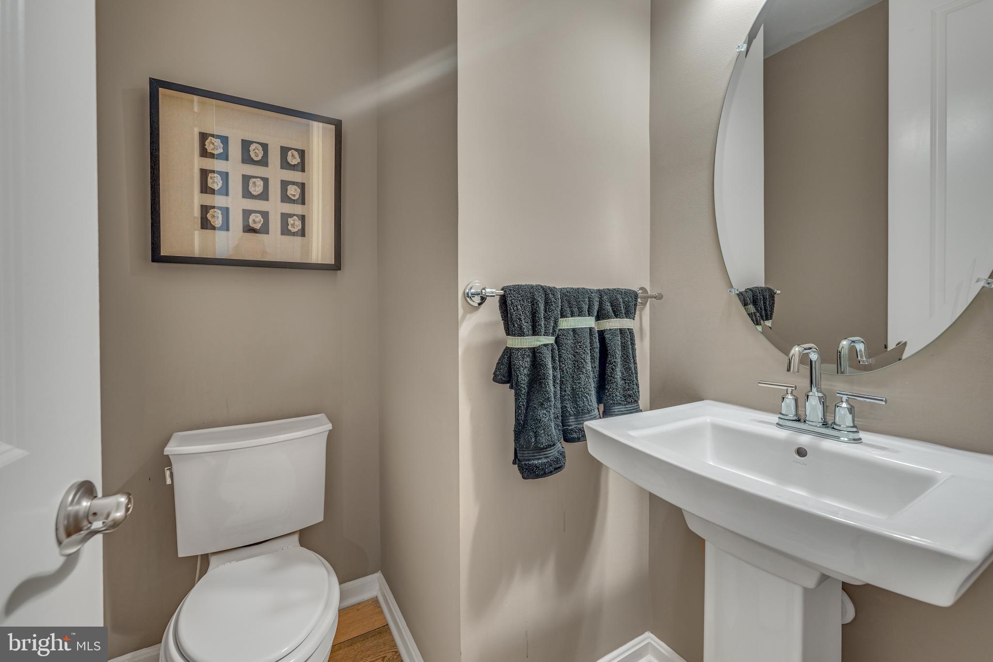 772 Honey Locust Road Middletown, DE 19709 - Photo 11 of 18 a bathroom with a toilet sink and mirror