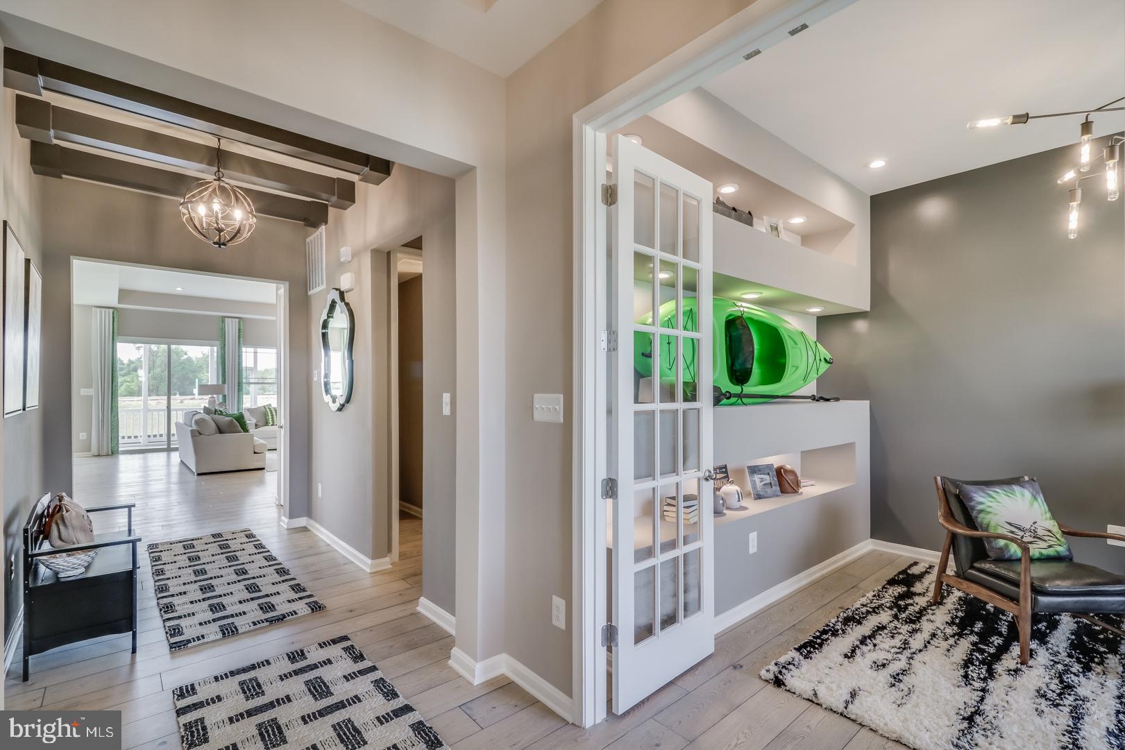 772 Honey Locust Road Middletown, DE 19709 - Photo 3 of 18 a view of a hallway with wooden floor and a livingroom view