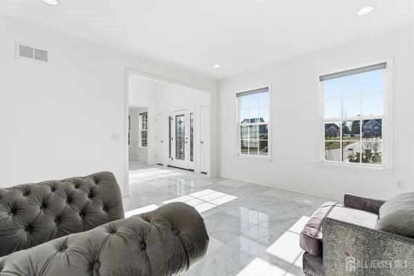 a living room with furniture and next to a window