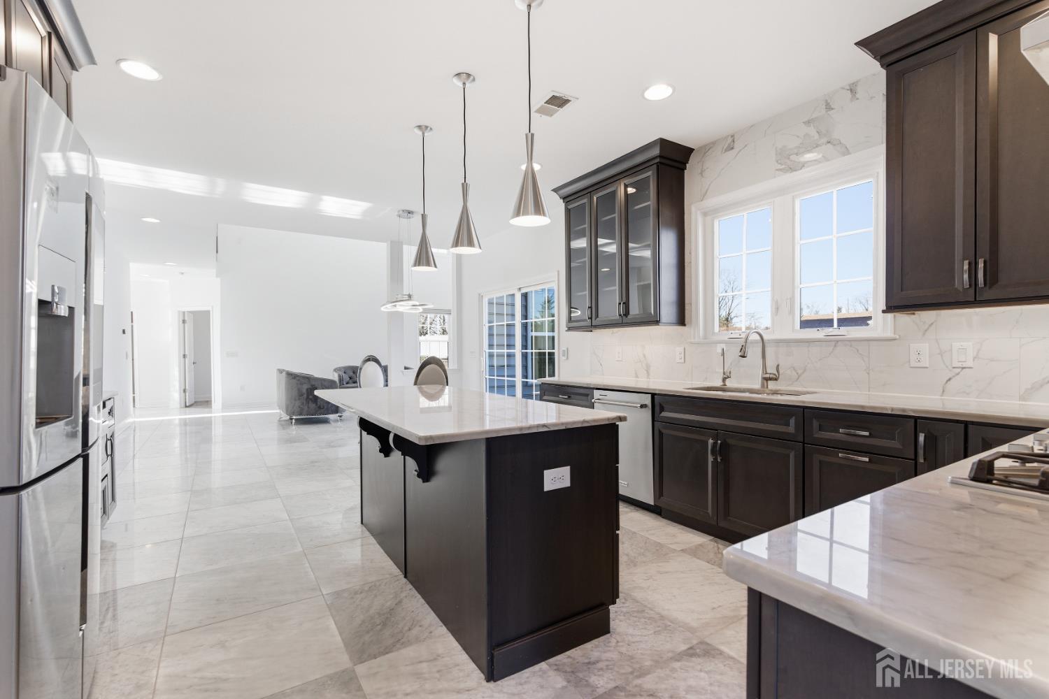 29 May Road East Brunswick, NJ 08816 - Photo 16 of 48 a kitchen with kitchen island granite countertop a sink counter top space and stainless steel appliances