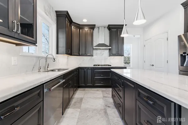 a kitchen with a sink and a stove top oven