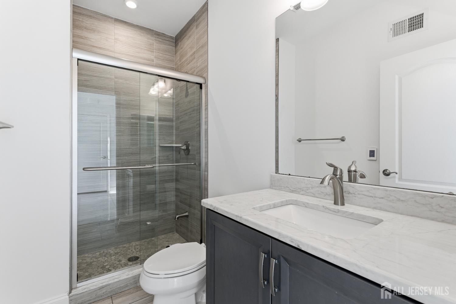 29 May Road East Brunswick, NJ 08816 - Photo 24 of 48 a bathroom with a sink a toilet and shower