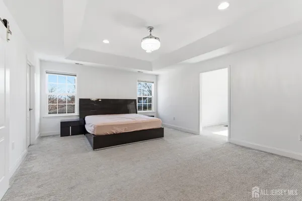 a spacious bedroom with a bed and window