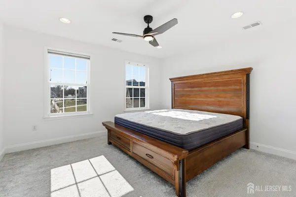 a bed sitting in a room next to a window