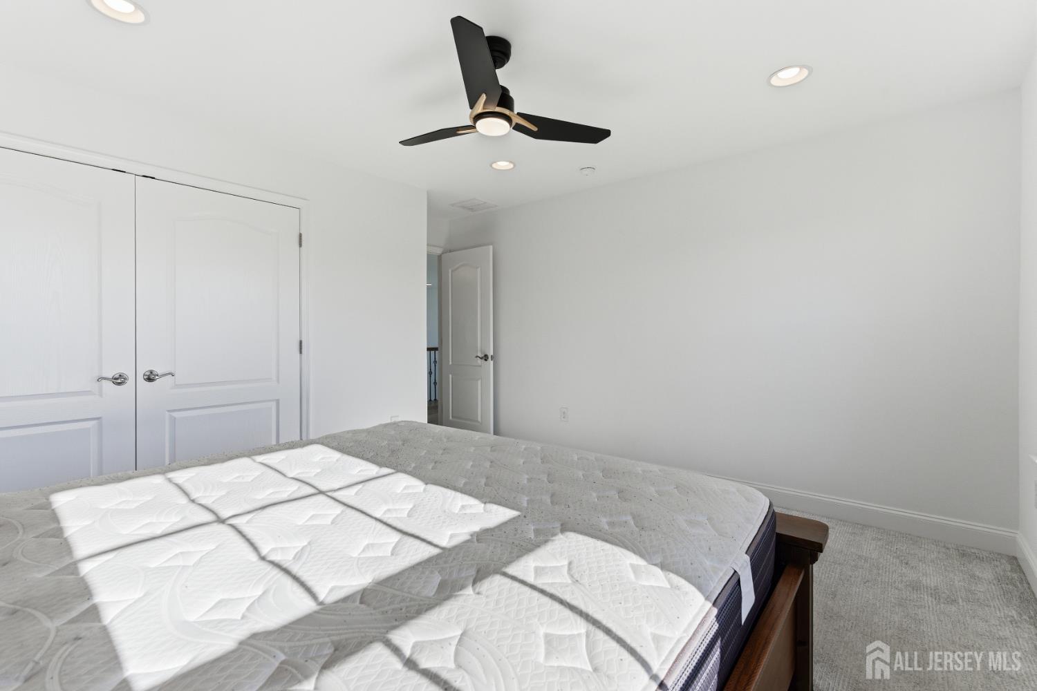 29 May Road East Brunswick, NJ 08816 - Photo 35 of 48 a bedroom with a bed and a chandelier