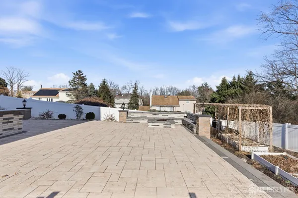 a view of roof deck with a barbeque and wooden stairs