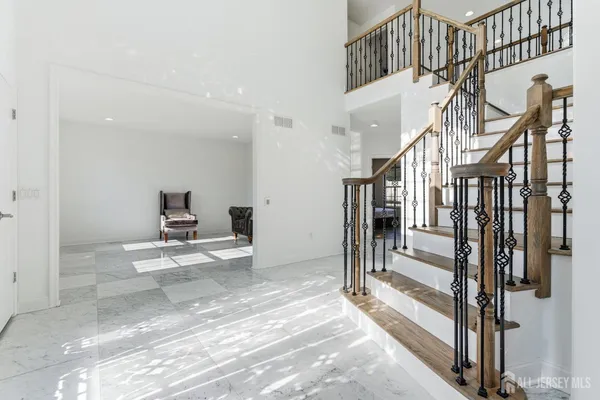 a view of a hallway with a livingroom and entryway