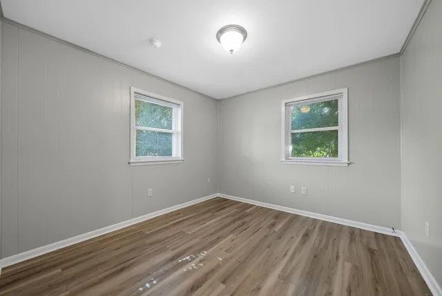 a view of room with hardwood floor and window