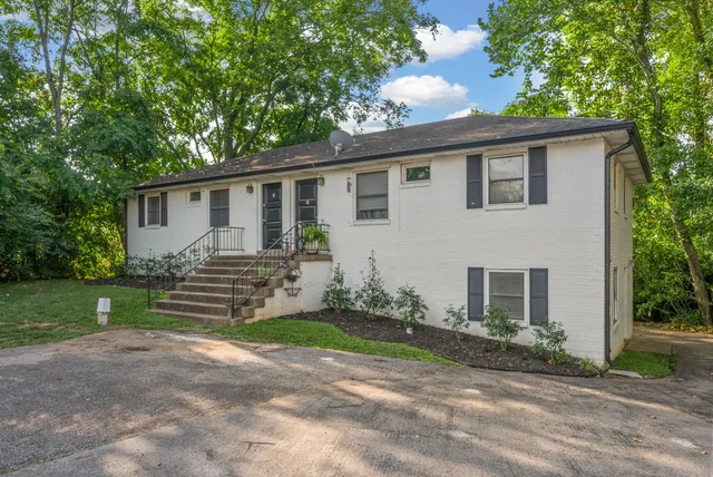 a front view of a house with a garden