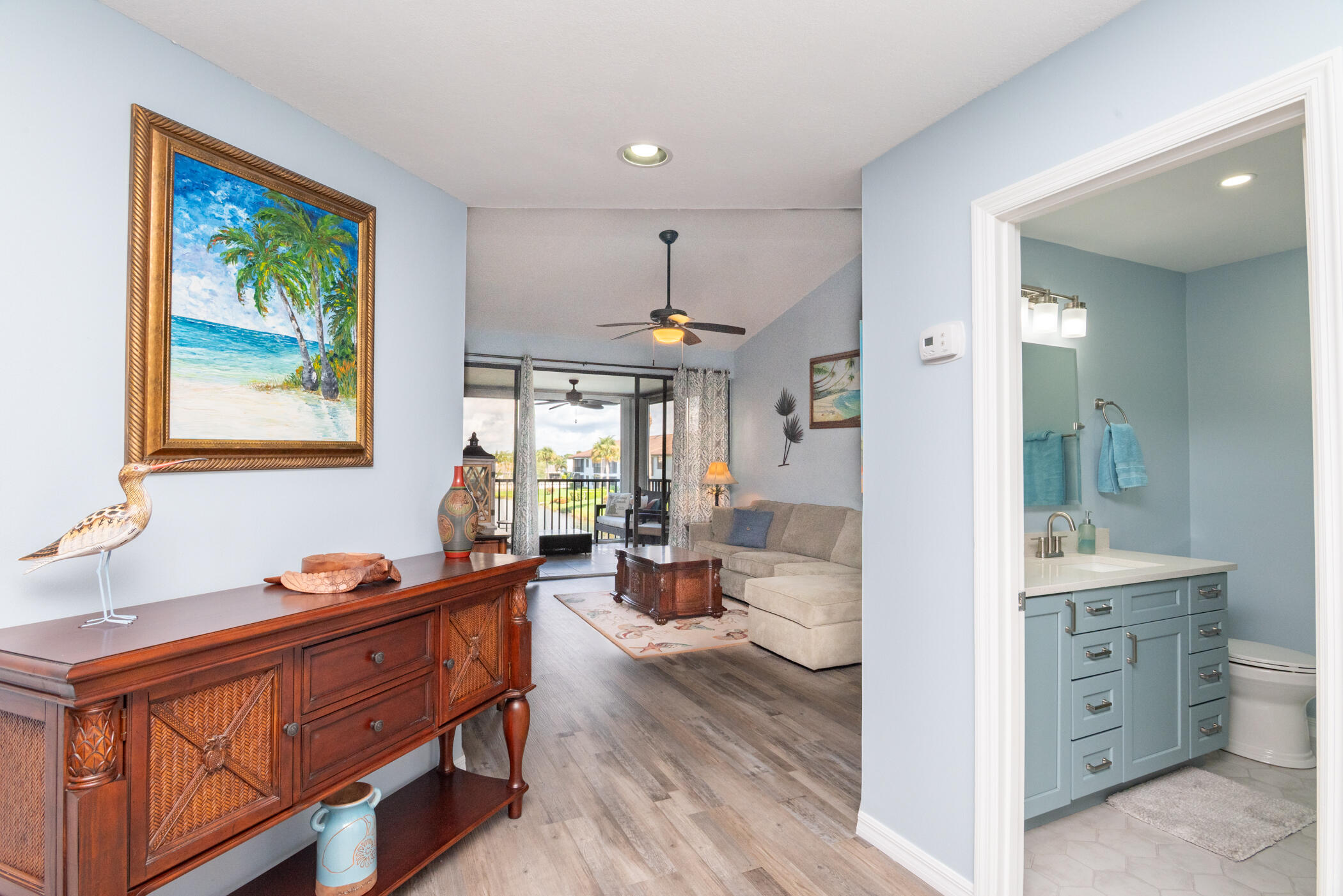 6041 Southeast Landing Way, Unit 17 Stuart, FL 34997 - Photo 11 of 37 a living room with furniture and a chandelier