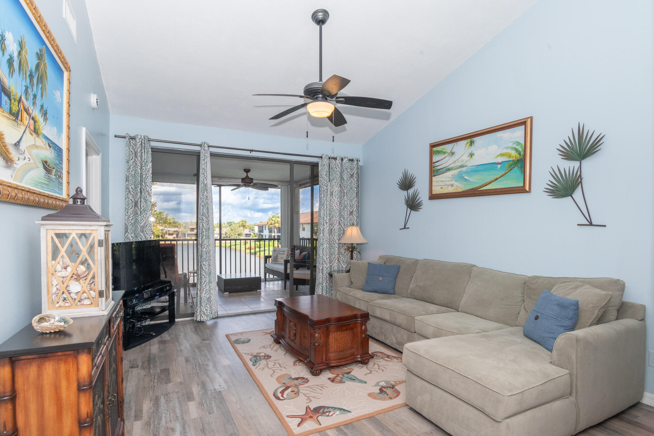 6041 Southeast Landing Way, Unit 17 Stuart, FL 34997 - Photo 14 of 37 a living room with furniture a fireplace and a flat screen tv