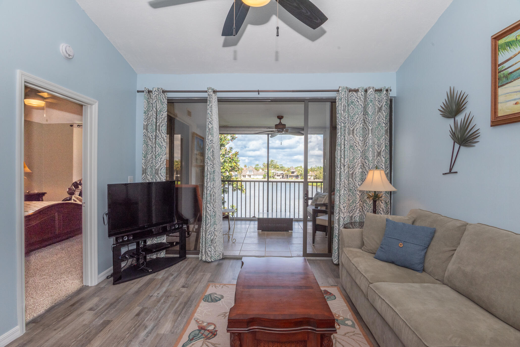 6041 Southeast Landing Way, Unit 17 Stuart, FL 34997 - Photo 17 of 37 a living room with furniture and a flat screen tv
