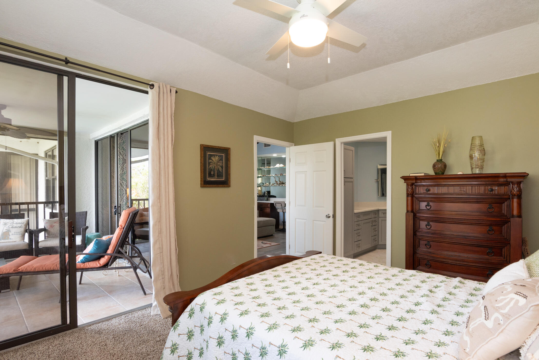 6041 Southeast Landing Way, Unit 17 Stuart, FL 34997 - Photo 18 of 37 a bedroom with a bed and a dresser