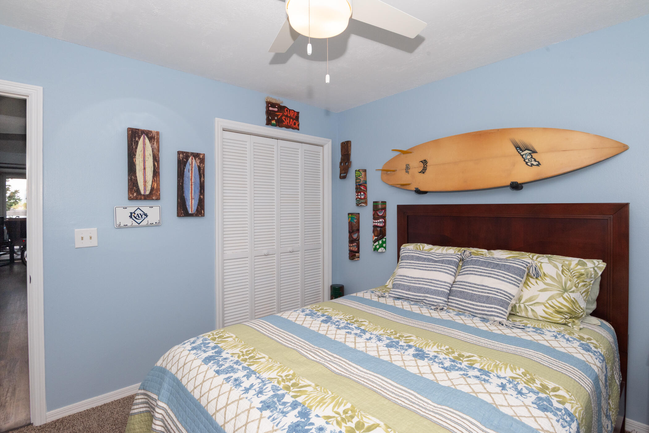 6041 Southeast Landing Way, Unit 17 Stuart, FL 34997 - Photo 22 of 37 a bedroom with a bed and a chandelier