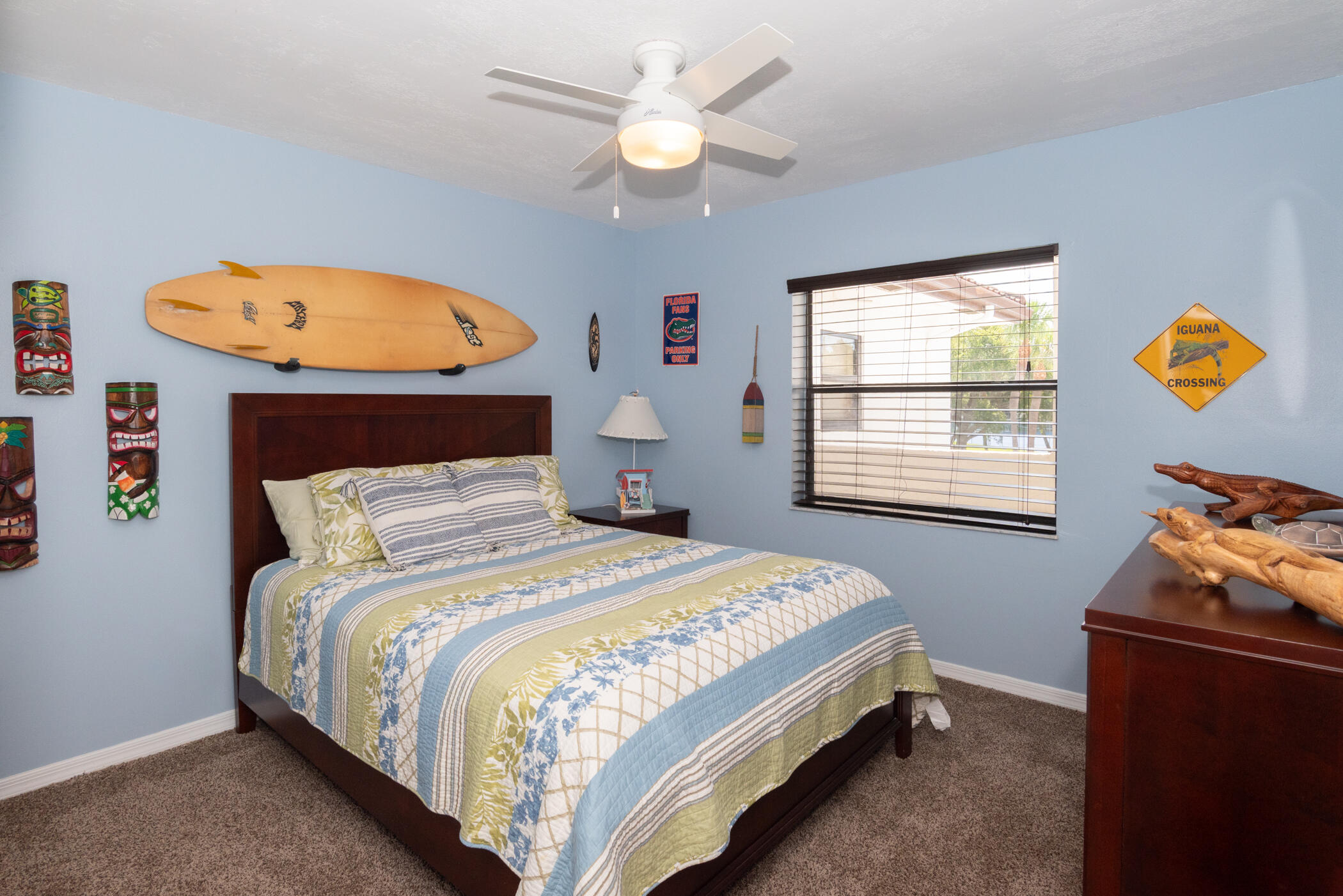 6041 Southeast Landing Way, Unit 17 Stuart, FL 34997 - Photo 23 of 37 a bedroom with a bed and a chandelier