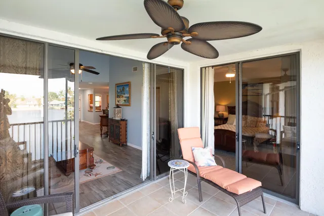 a living room with furniture and a ceiling fan