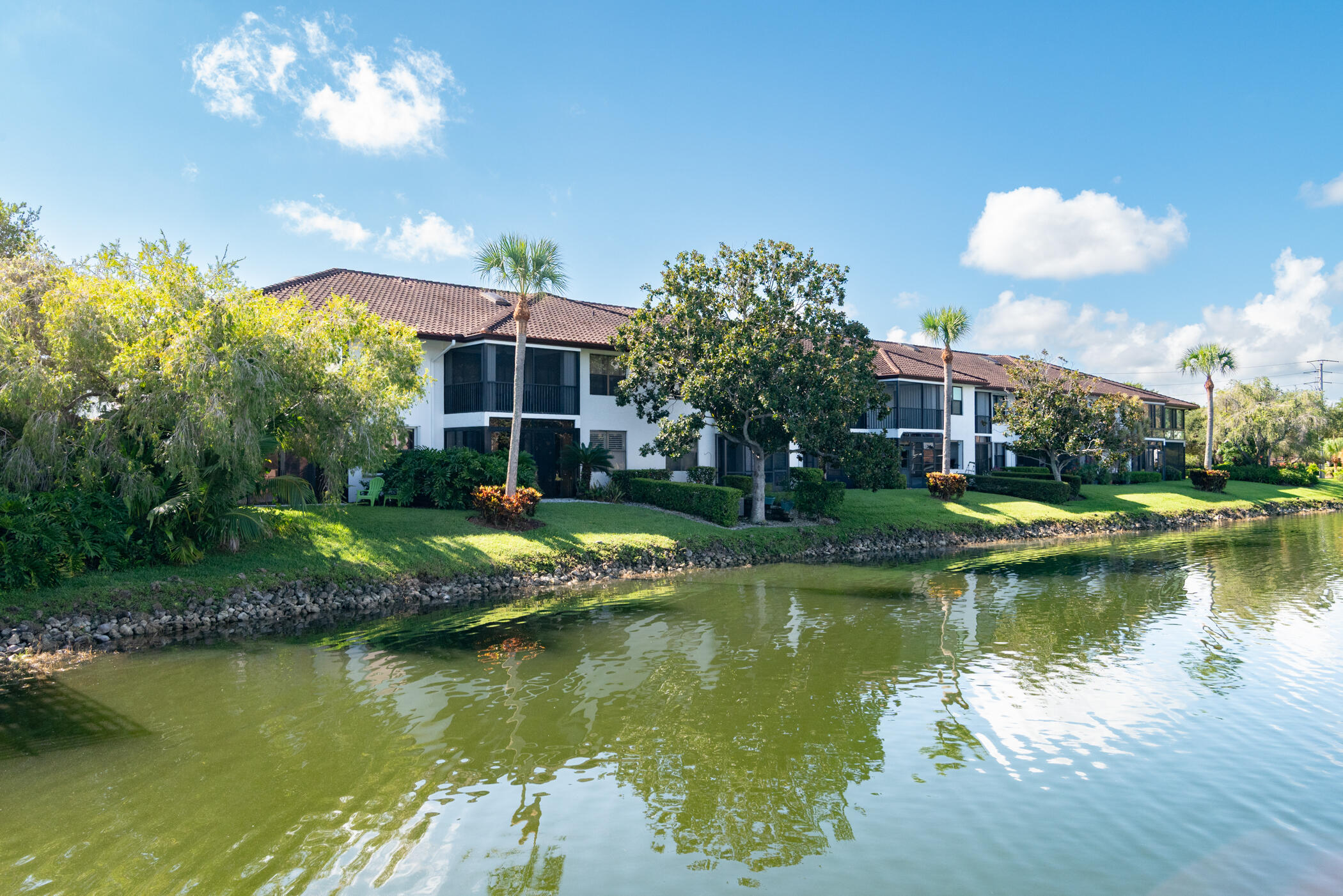 6041 Southeast Landing Way, Unit 17 Stuart, FL 34997 - Photo 28 of 37 a view of a house with a yard and a garden