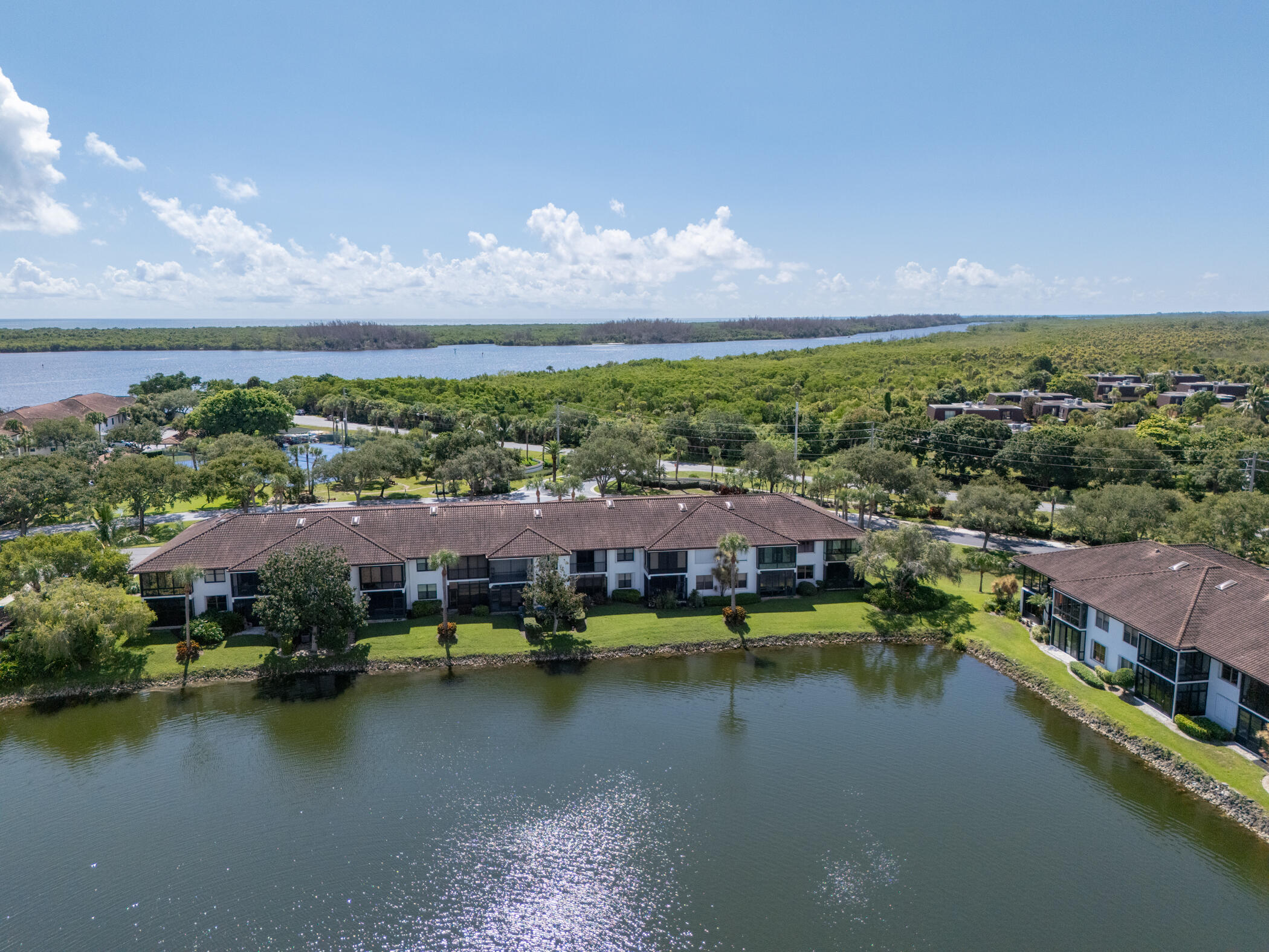 6041 Southeast Landing Way, Unit 17 Stuart, FL 34997 - Photo 31 of 37 an aerial view of residential houses with outdoor space and lake view