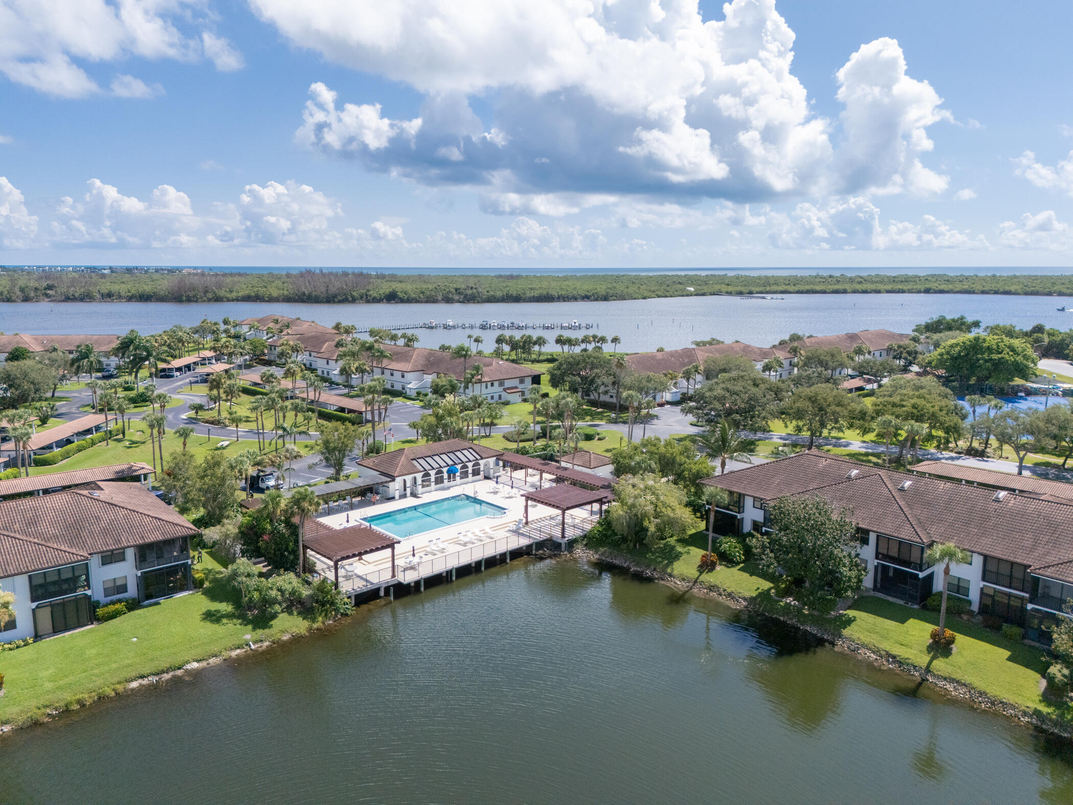 6041 Southeast Landing Way, Unit 17 Stuart, FL 34997 - Photo 32 of 37 a view of a lake with houses in back