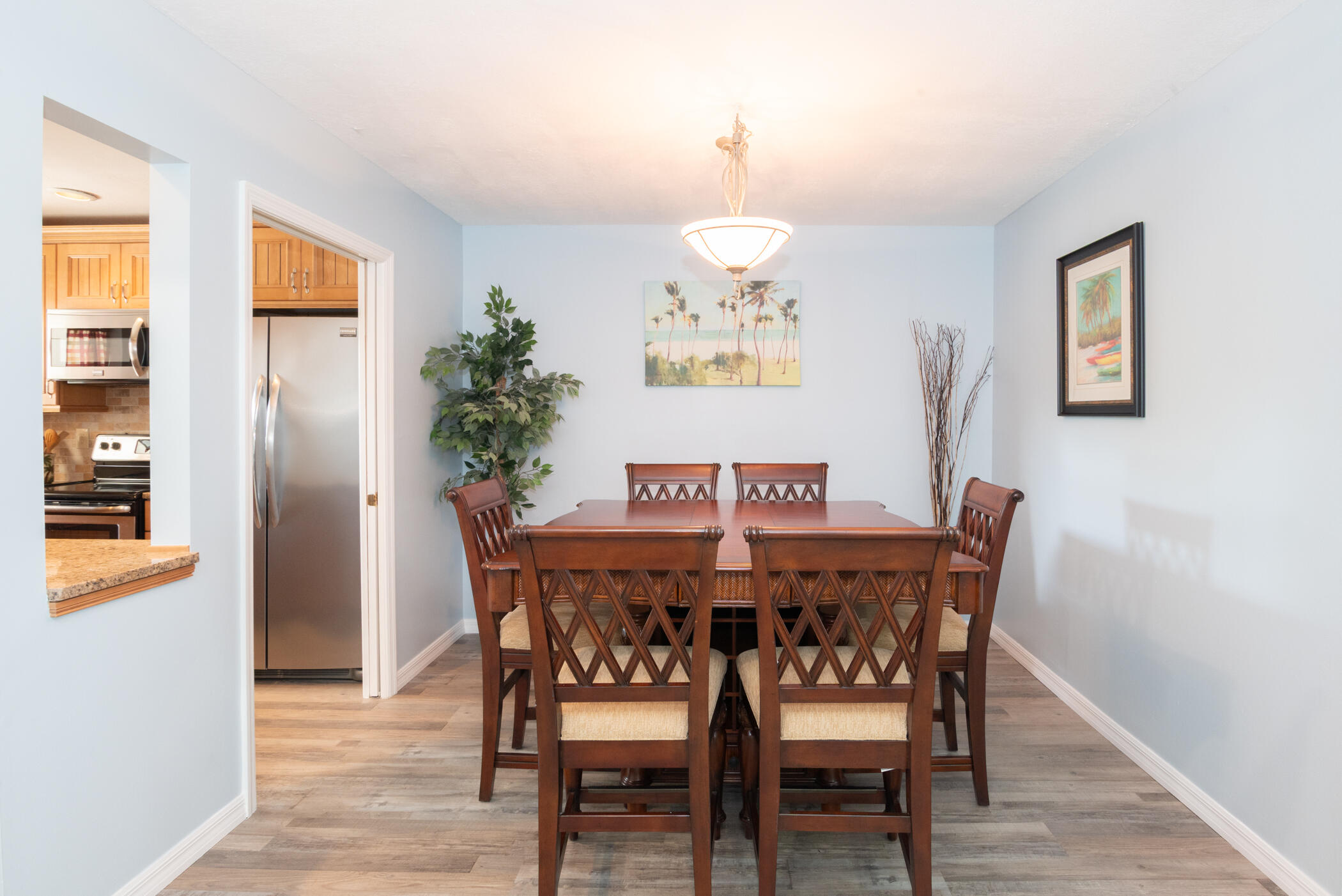 6041 Southeast Landing Way, Unit 17 Stuart, FL 34997 - Photo 6 of 37 a view of a dining room with furniture and wooden floor