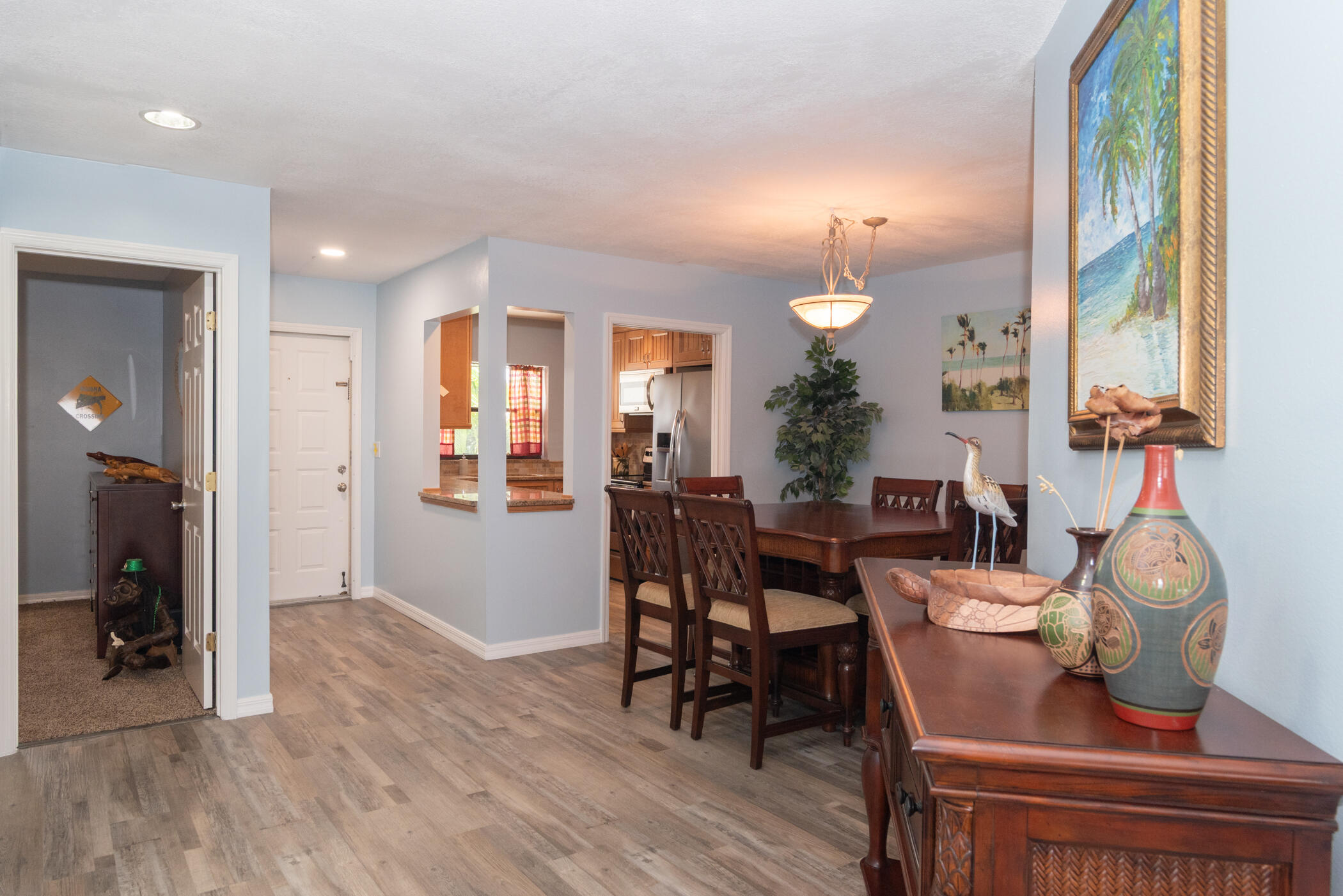 6041 Southeast Landing Way, Unit 17 Stuart, FL 34997 - Photo 8 of 37 a view of a dining room with furniture and wooden floor