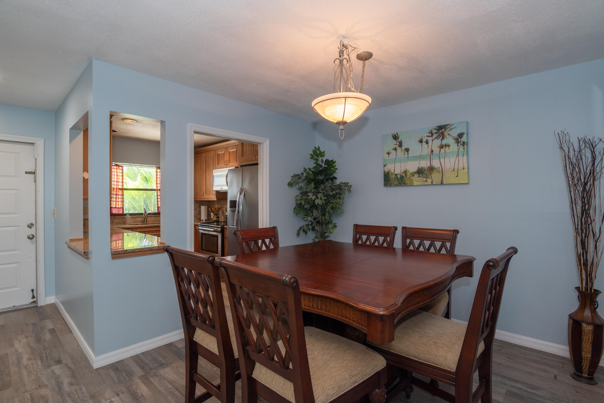 6041 Southeast Landing Way, Unit 17 Stuart, FL 34997 - Photo 9 of 37 a view of a dining room with furniture and wooden floor