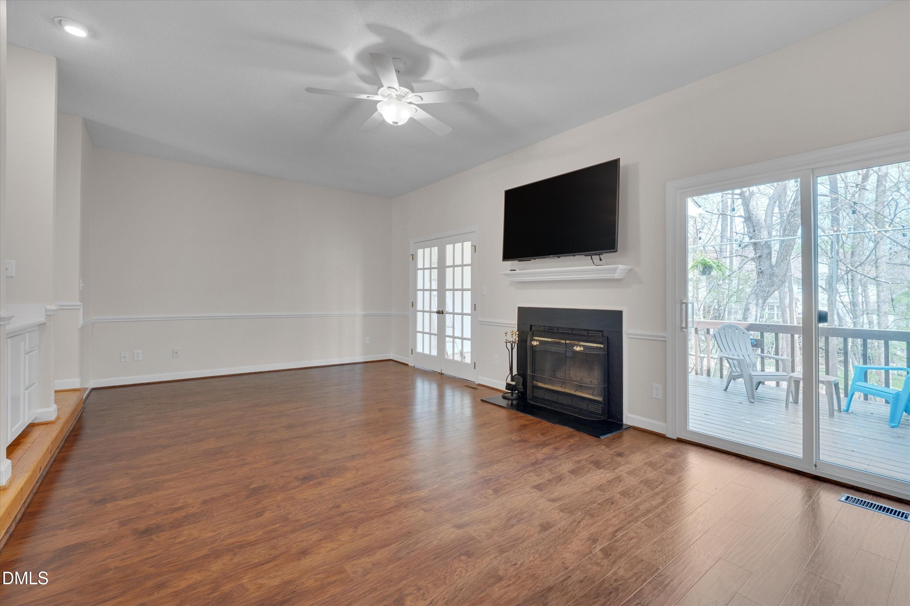3 Preakness Drive Durham, NC 27713 - Photo 12 of 62 a view of a livingroom with a fireplace wooden floor and windows